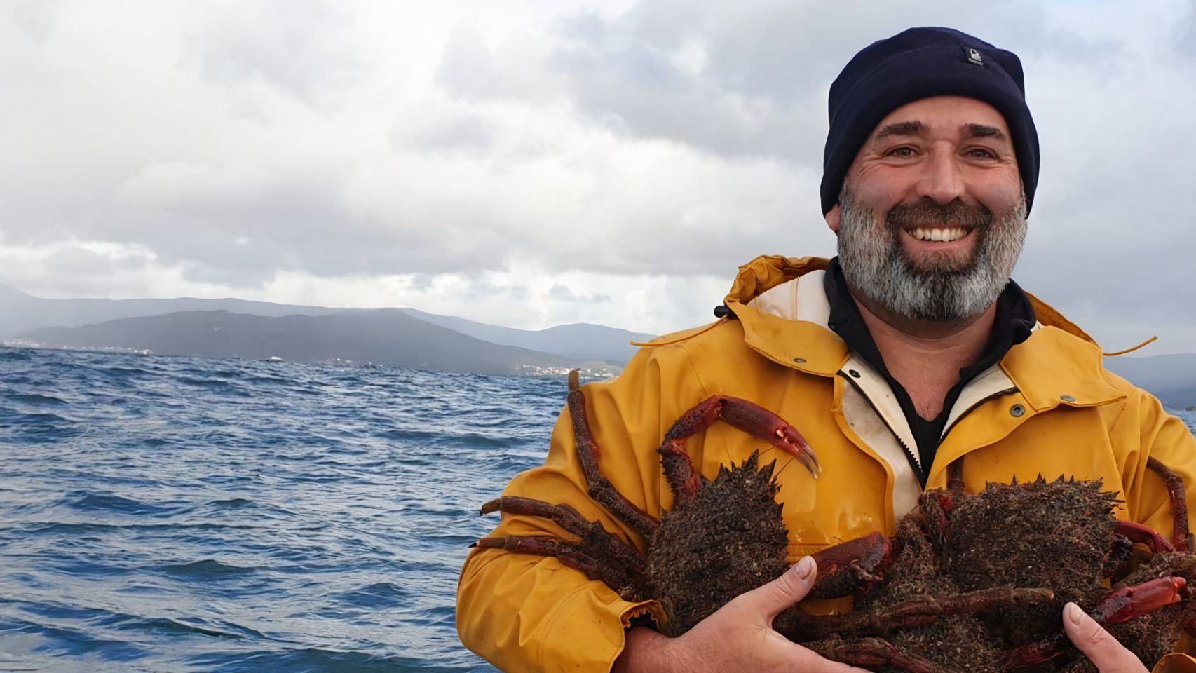 Rogelio Santos Queiruga, no barco, con dúas centolas.