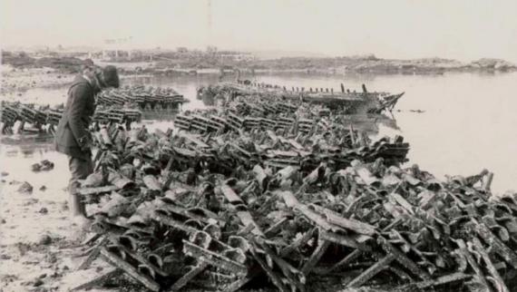 Balck & white picture of person looking at wooden shellfishing apparel